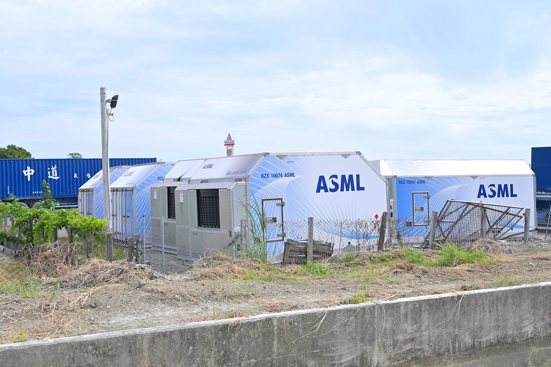Large main-deck air cargo containers used to fly semiconductor manufacturing equipment, parked outdoors