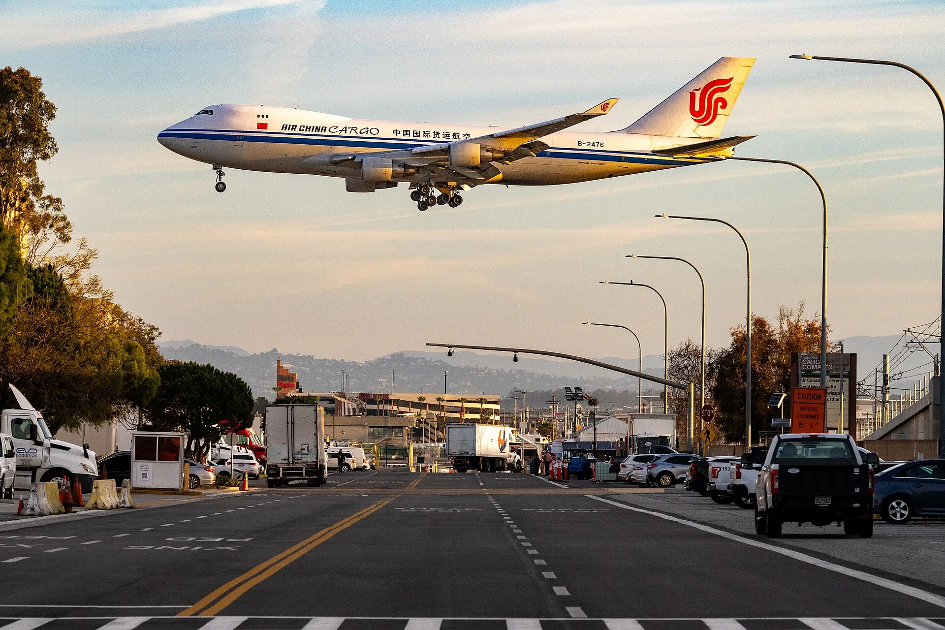 Boeing 747-400F cargo aircraft on final approach over a street next to Los Angeles International Airport