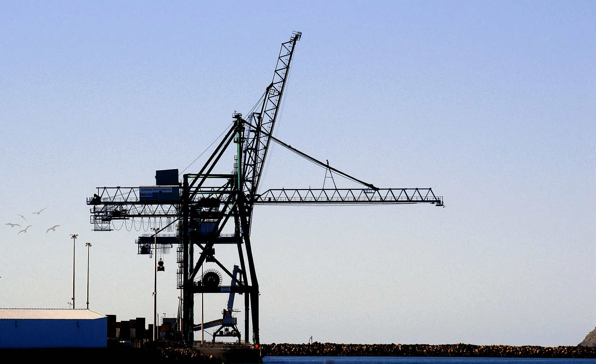 Ship-to-shore gantry crane at a container terminal with stacked shipping containers