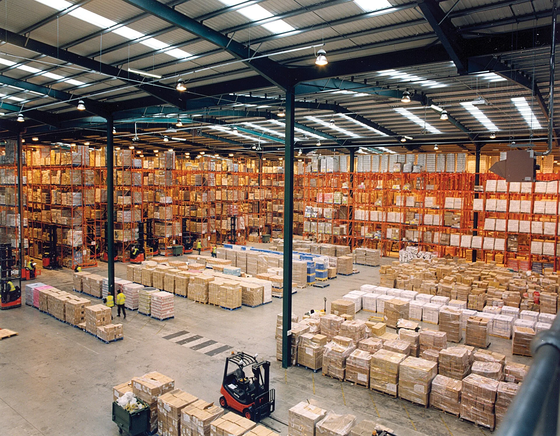 Interior of a large warehouse with pallet racks and palletized freight on the floor