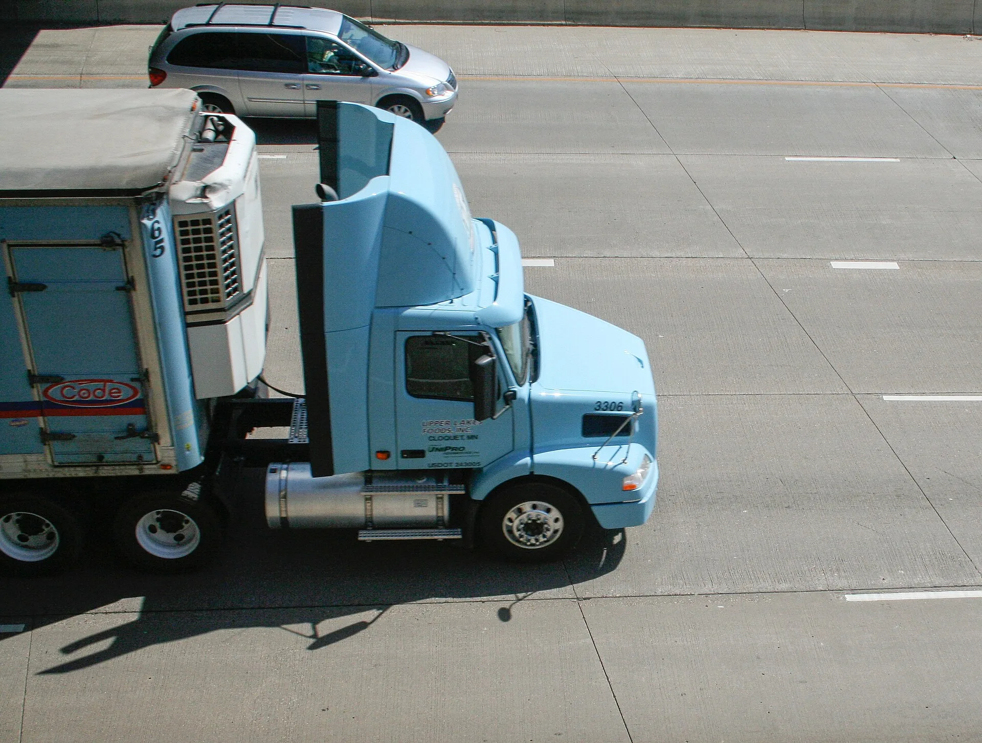 Tractor-trailer traveling on an interstate highway, seen from above