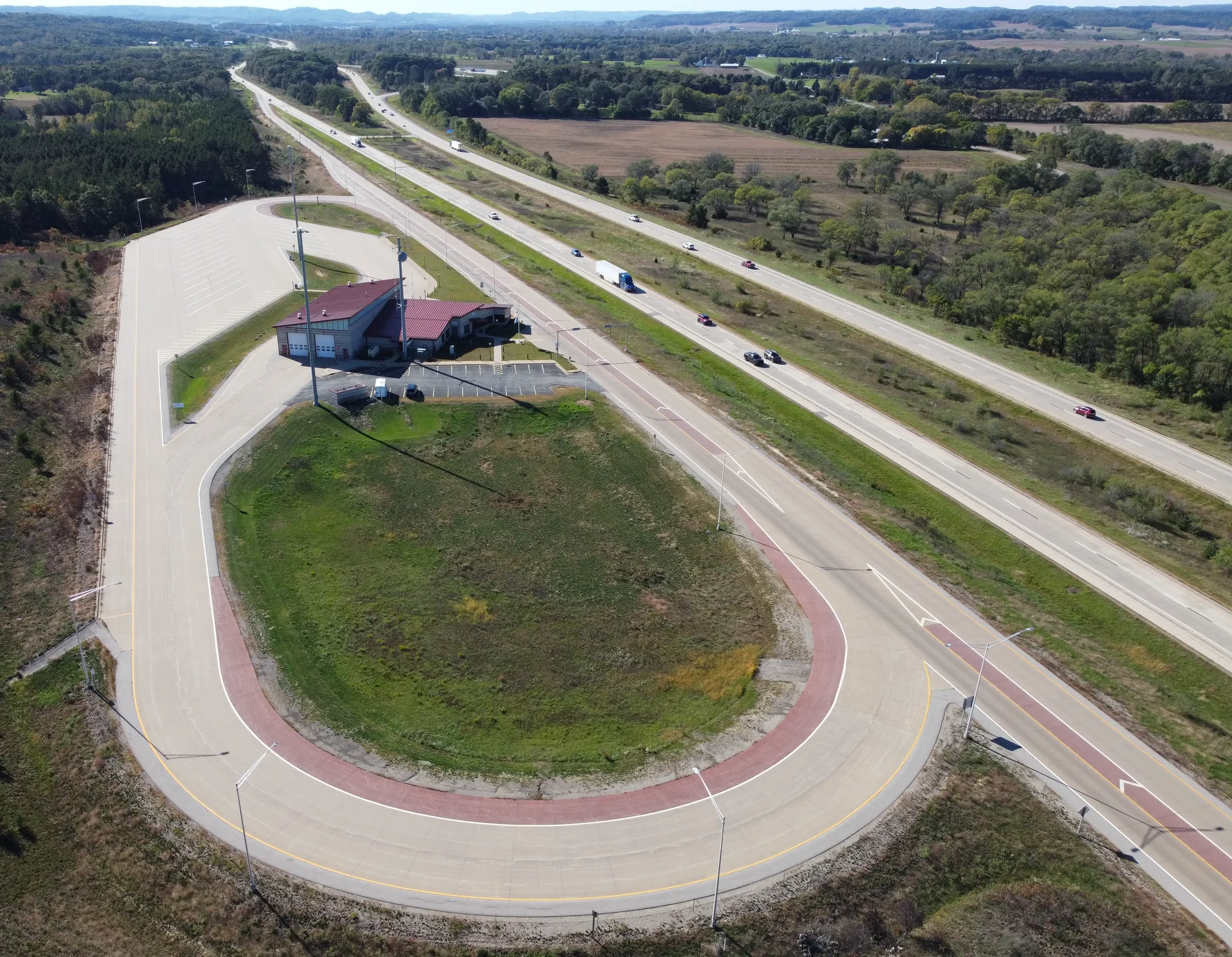 Aerial view of a truck weigh station beside a divided highway